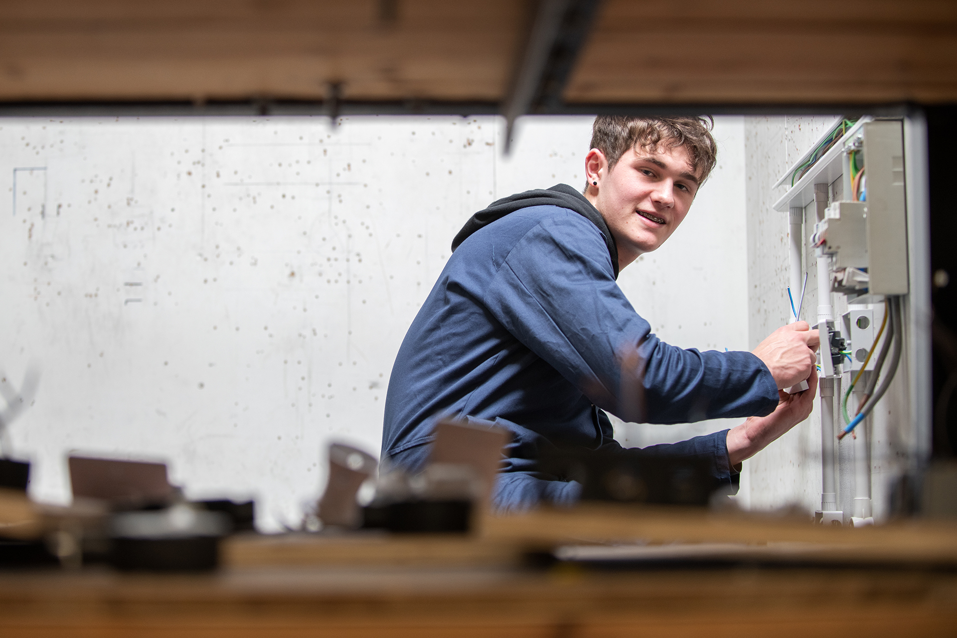Electrical engineering student working with cables in electrics.